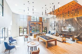 A living room with a fireplace and a pool table